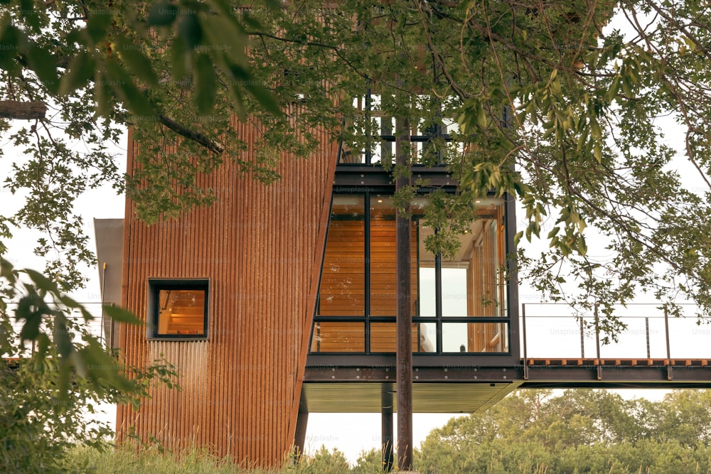 a tall wooden building with a glass window on top of it