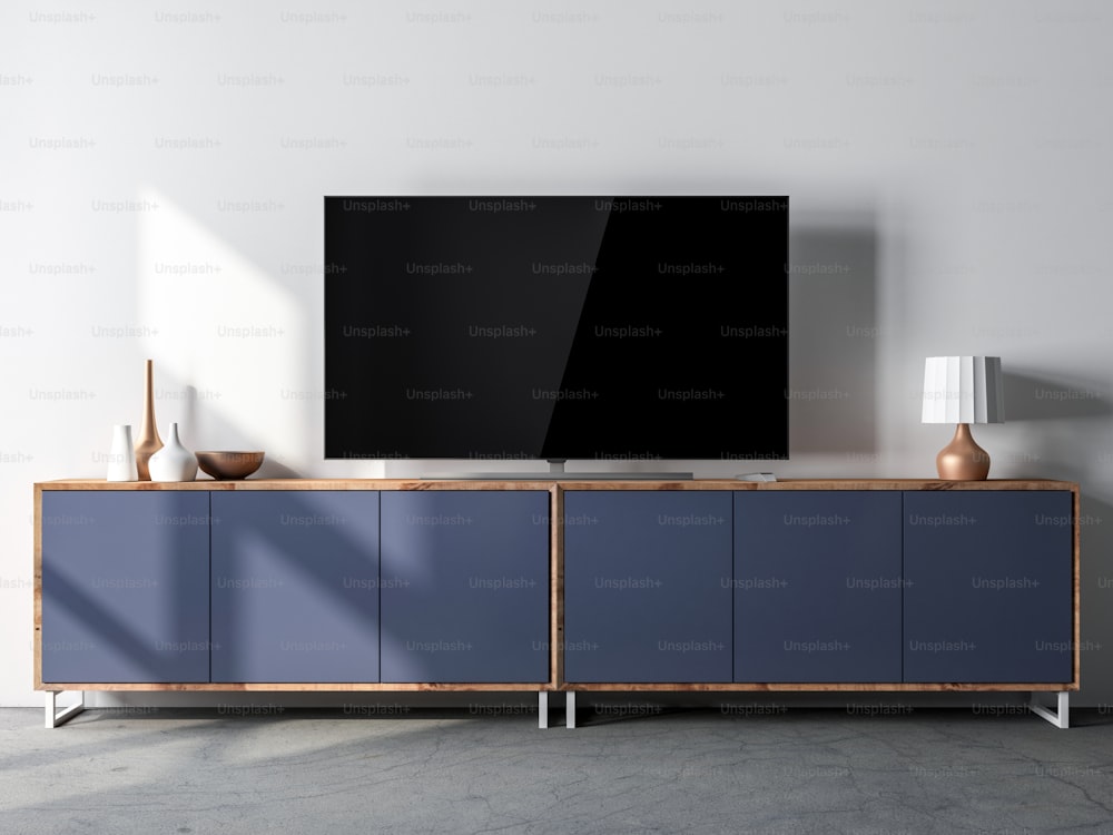 Maquette d’écran Smart Tv debout sur un bureau bleu dans un intérieur moderne, rendu 3D