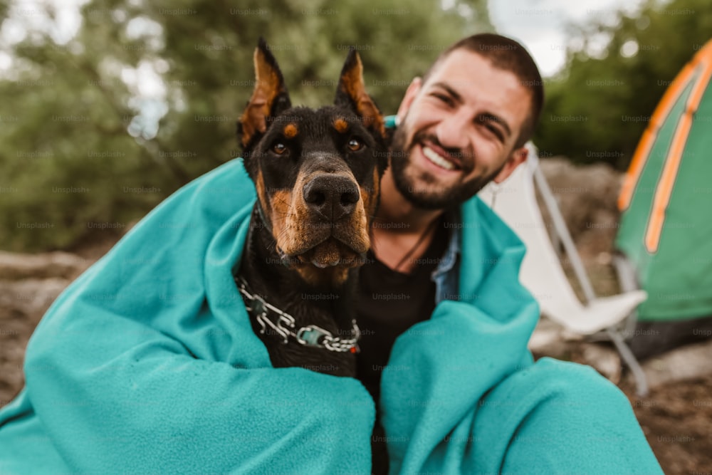 Hombre viajando con perro, acampando en la naturaleza.