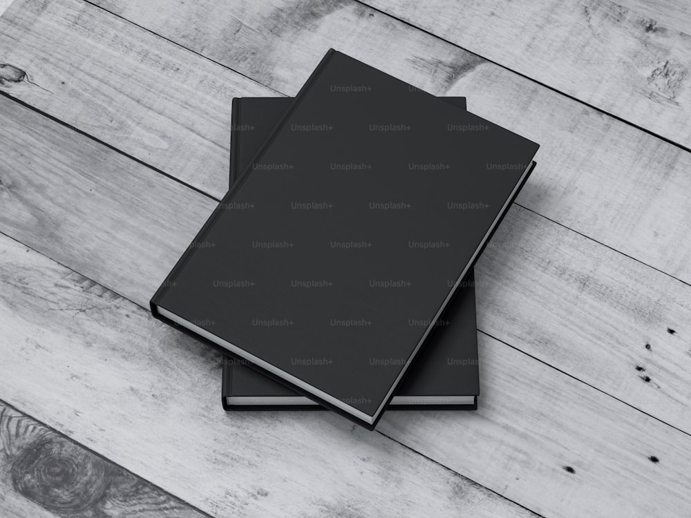 屋外の白いテーブルにテクスチャー加工されたクラフトハードカバーのモックアップ2冊の黒い本。3Dレンダリング