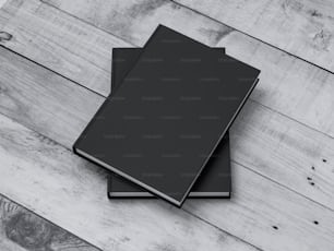 Deux livres noirs Maquette avec couverture rigide kraft texturée sur table blanche en plein air. Rendu 3D