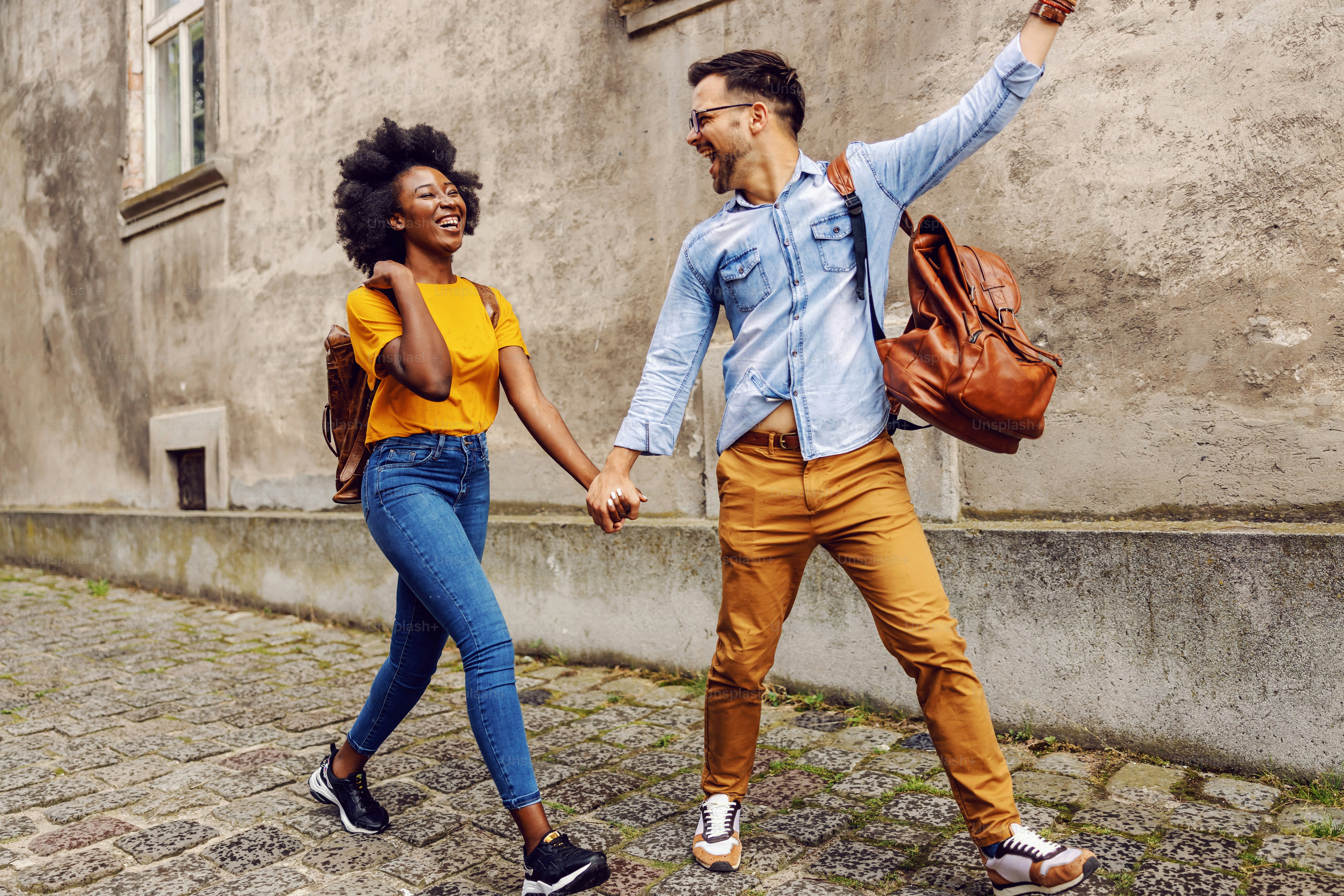 Young cute multicultural couple taking a walk in an old part of the town.