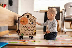 Adorable toddler playing interactive games for good development at home.