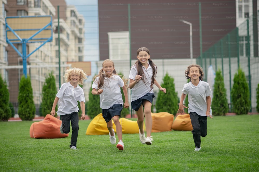 After school. Group of children running and looking excited
