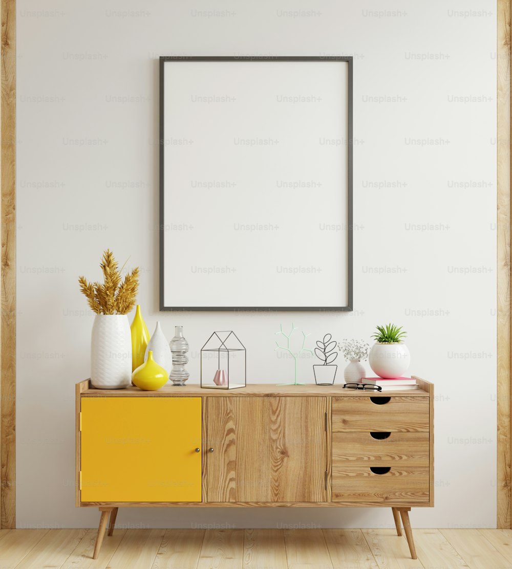 Maqueta del marco del póster en el gabinete en el interior, pared blanca.3d renderizado