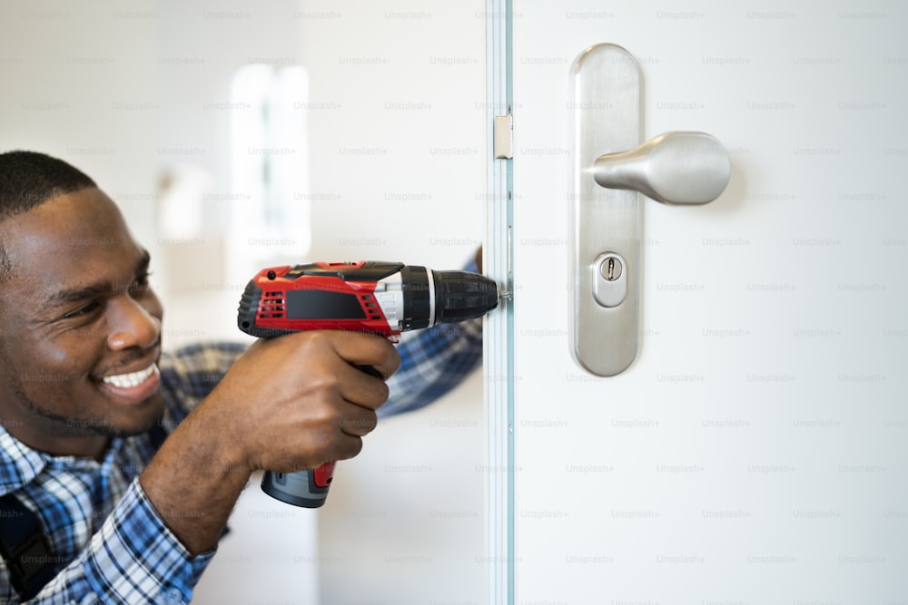 African Locksmith Man Changing And Fixing Door Lock