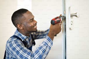 African Locksmith Man Changing And Fixing Door Lock