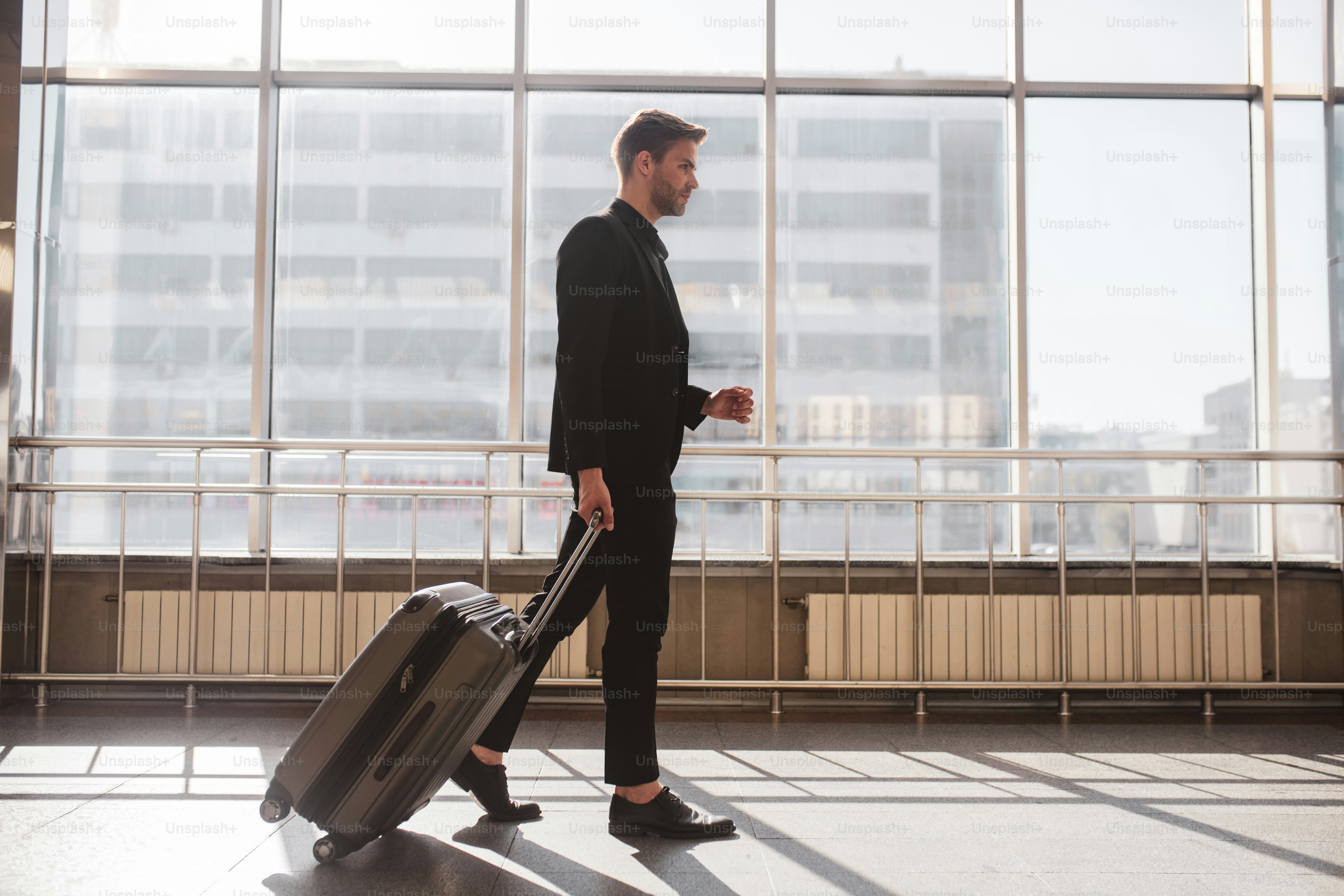 Airport. A man walking through the airport with his suitcase