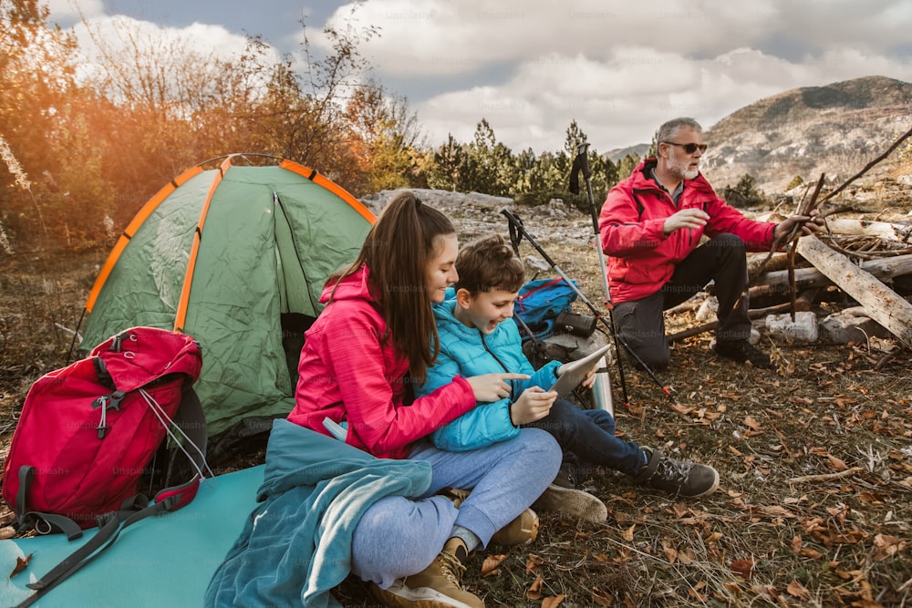 Happy family on a camping trip. Family doing camping in the forest