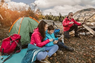 Happy family on a camping trip. Family doing camping in the forest