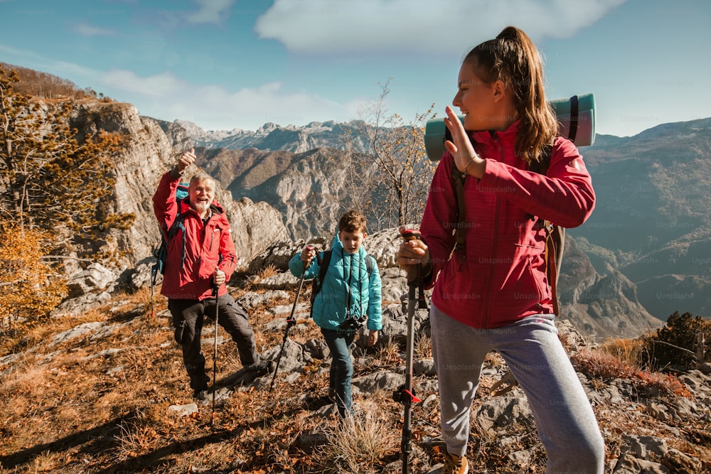 Father with two kids hiking in mountains