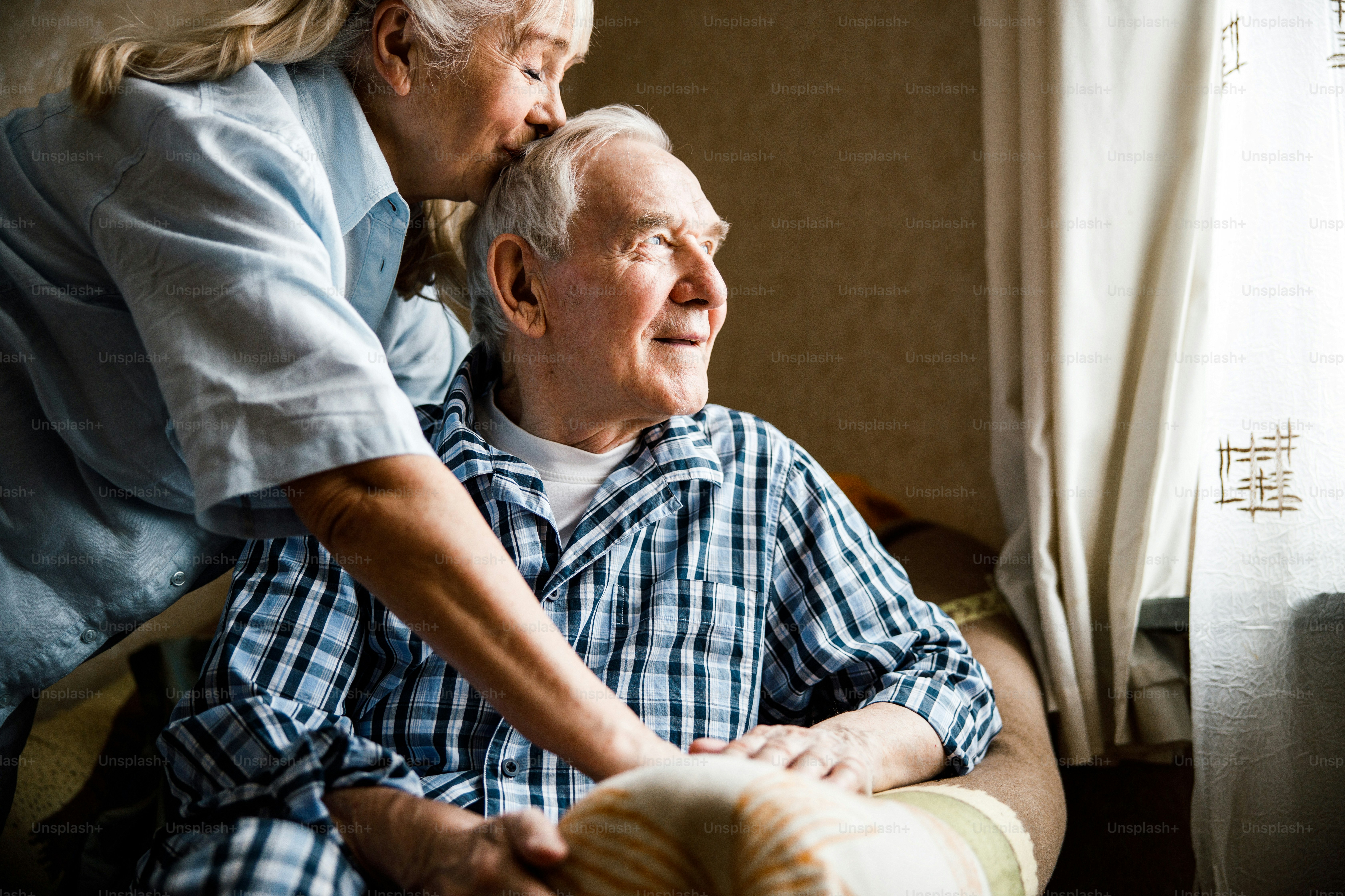 Wonderful mood. Happy delighted man smiling while sitting at the ...