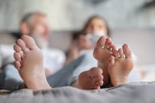 Cozy morning. Man and woman staying in bed together in the morning