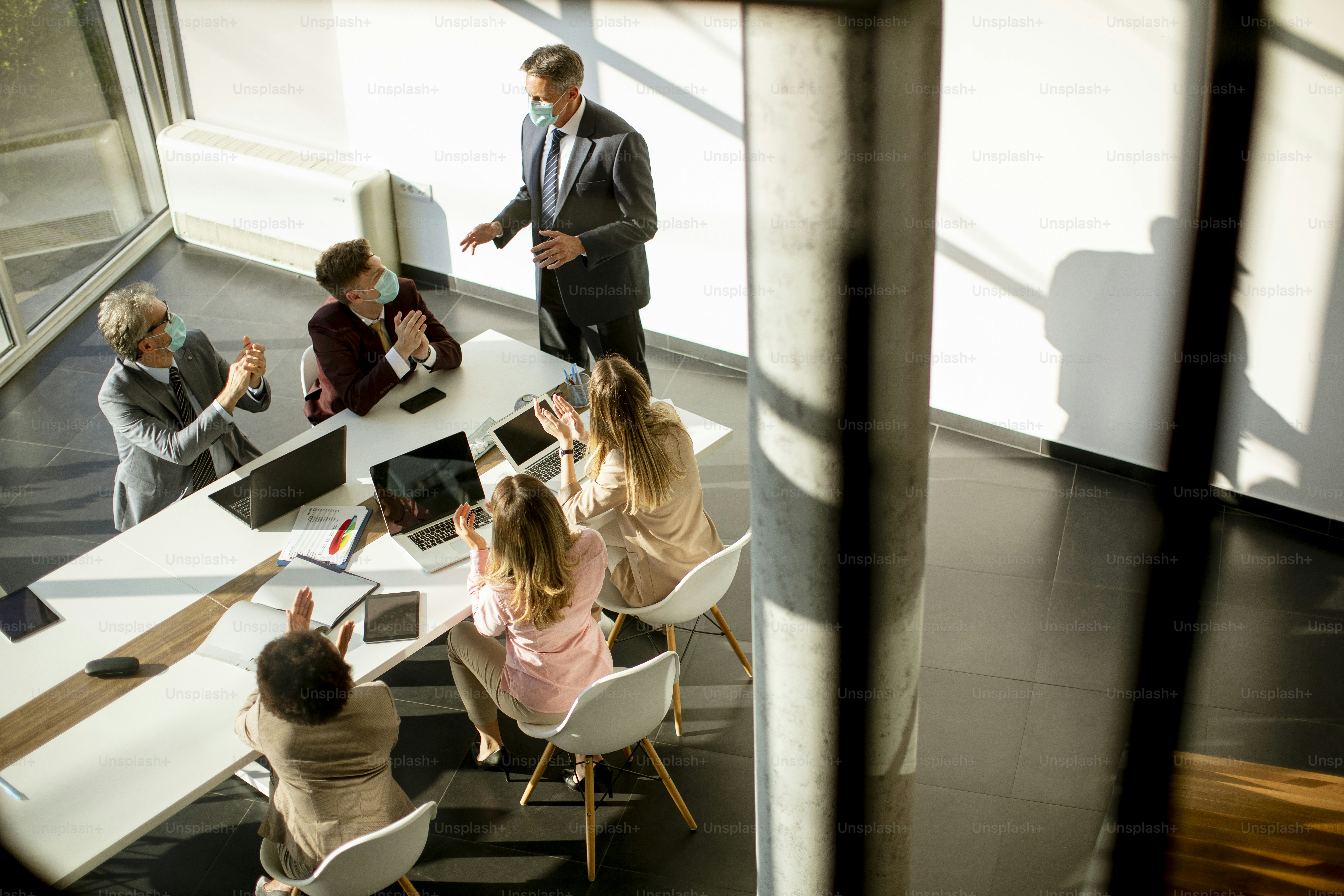 Aerial view at multiethnic group of business people working together and preparing new project on a meeting in the office