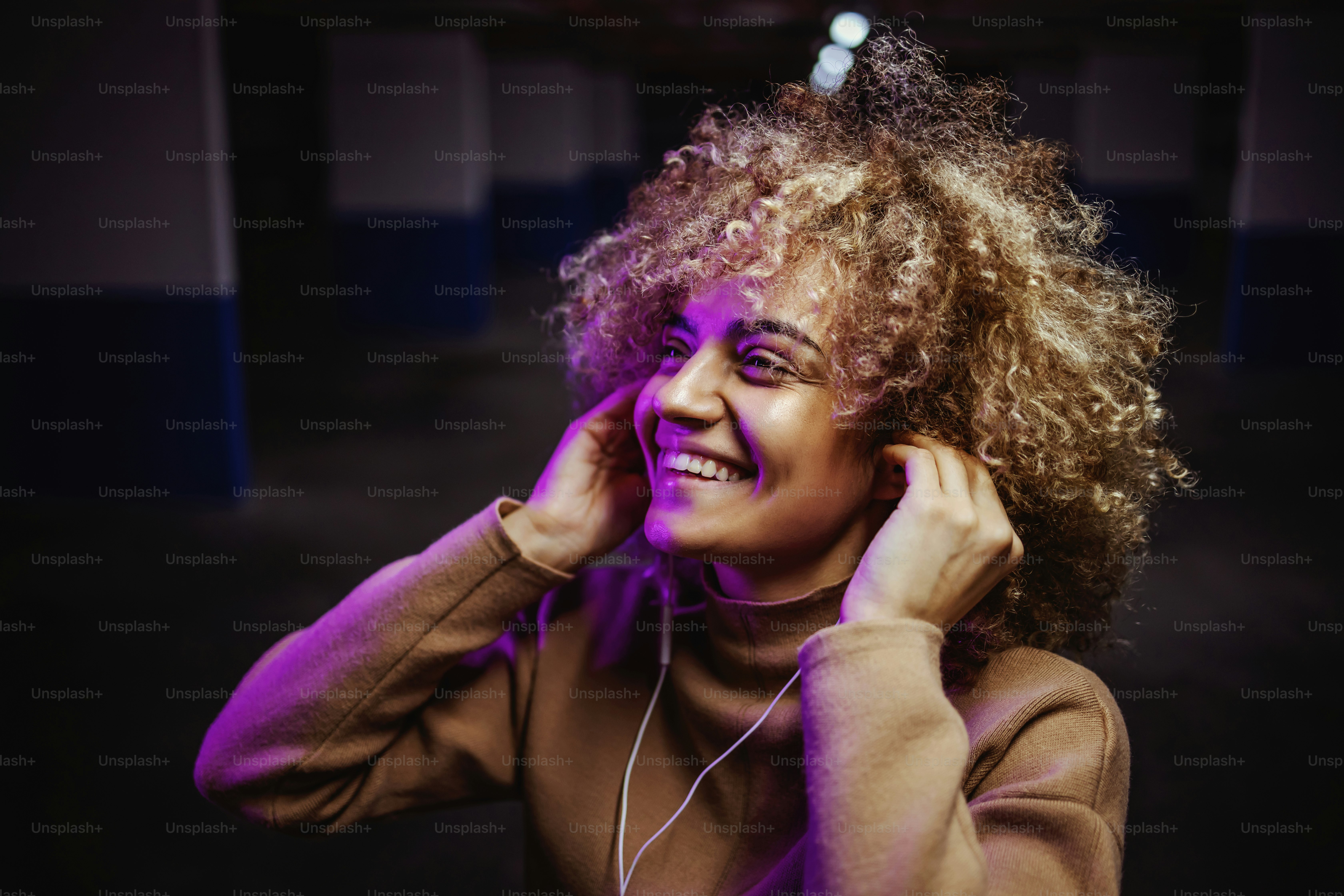 Smiling mixed race hip hop girl standing in underground garage and ...