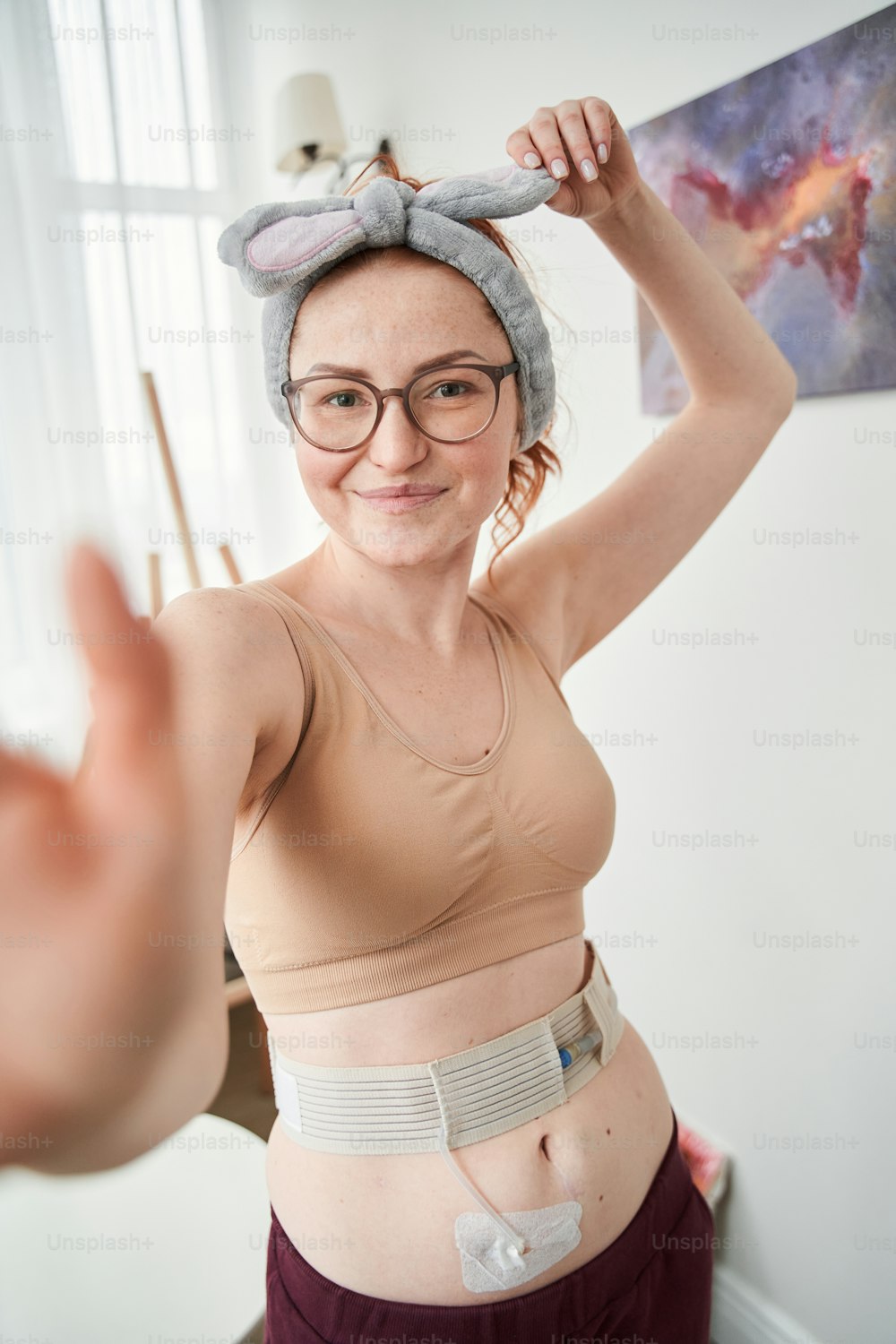 Portrait view of smiling young caucasian woman taking self-portrait picture of herself in own house home. Happy millennial female making selfie on good quality smartphone camera