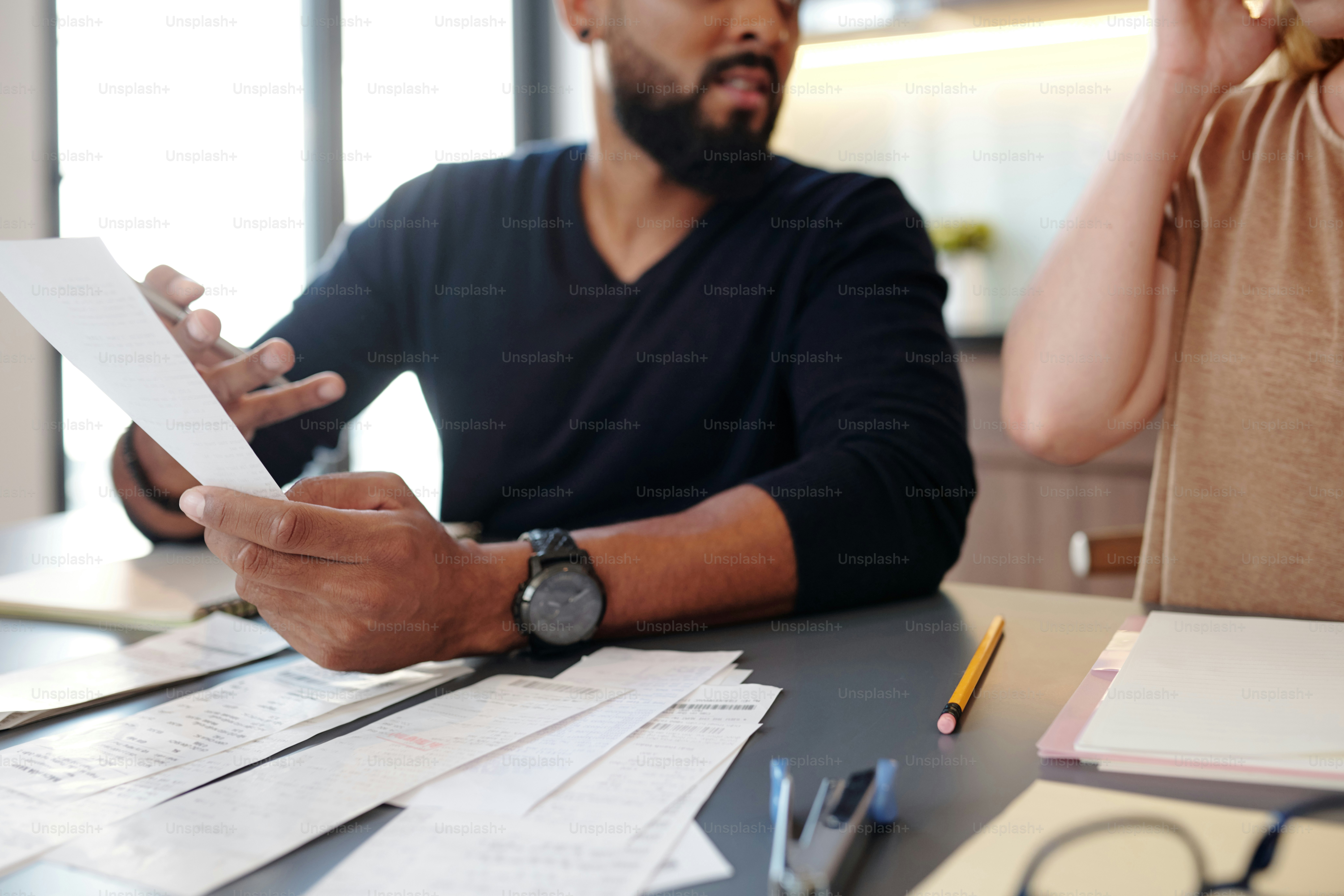 Man showing bill to wife and asking why she spent so much money