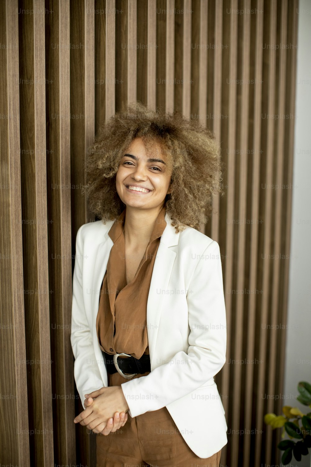 Pretty young curly hair woman standing in modern office