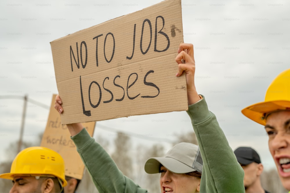 Hands of engineers holding messages of protest on strike