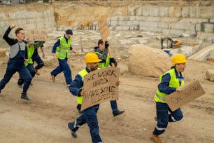 Crowd of protestants with placards running after their employer during strike