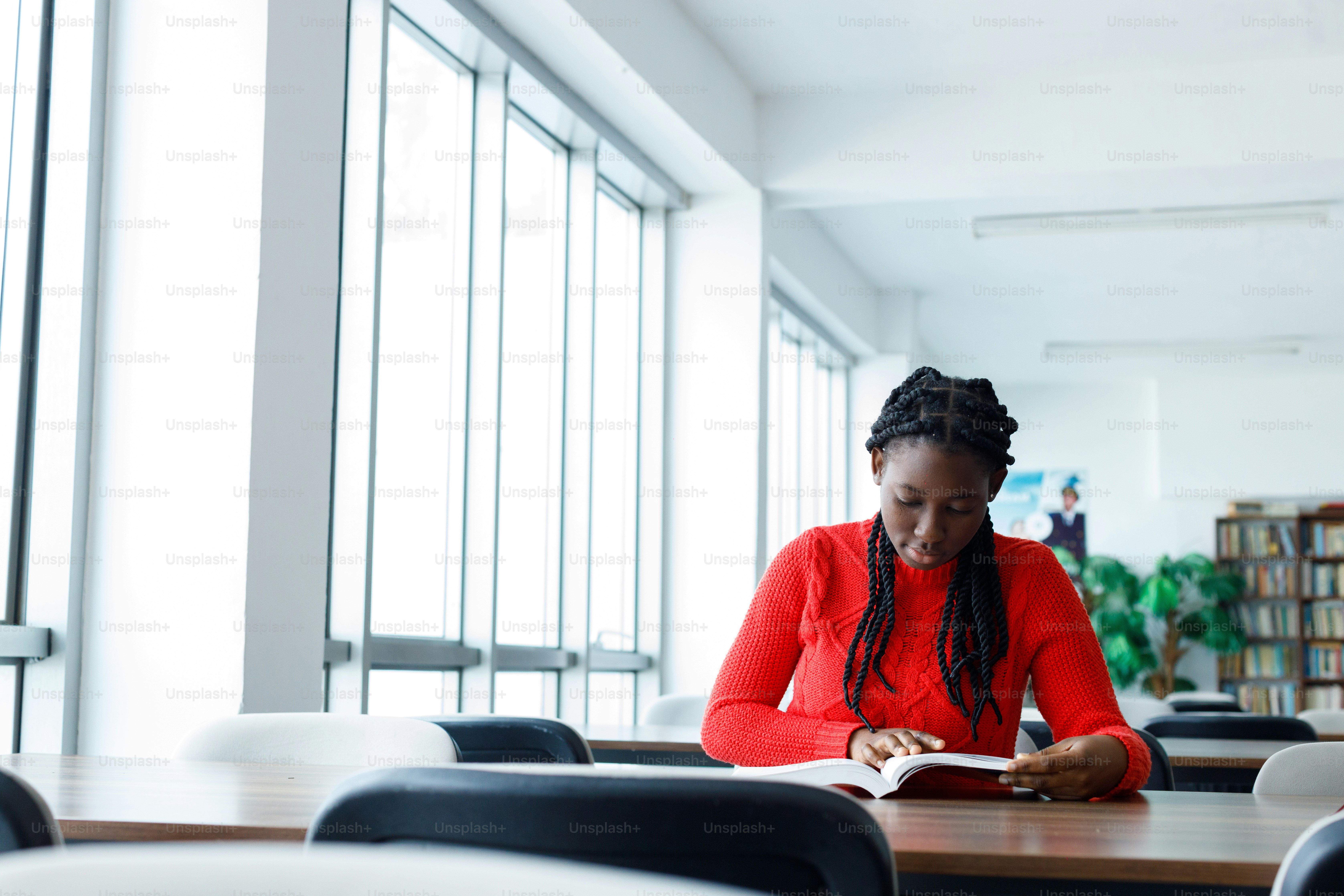 a woman sitting at a table with a book