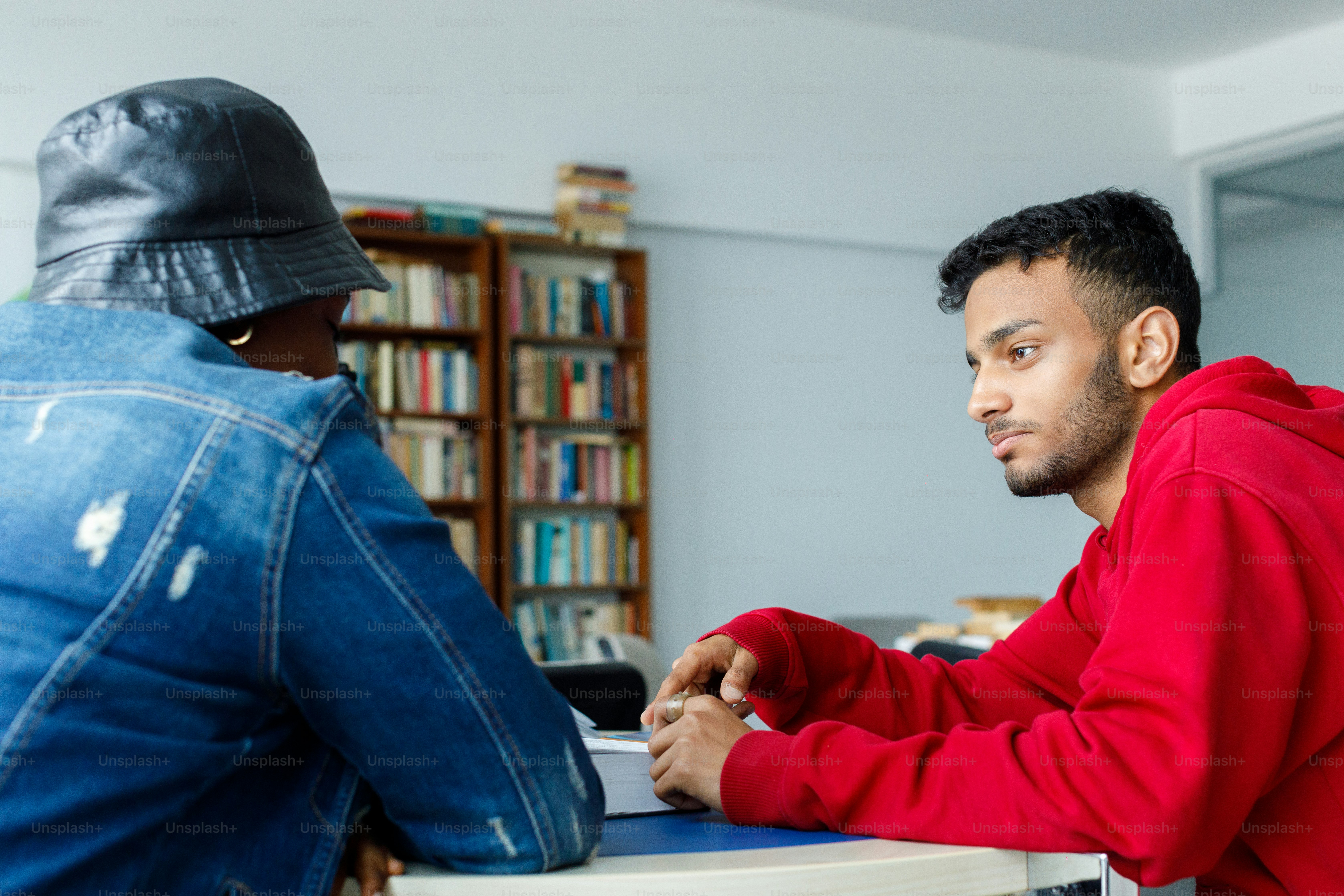 a man sitting at a table with a laptop computer