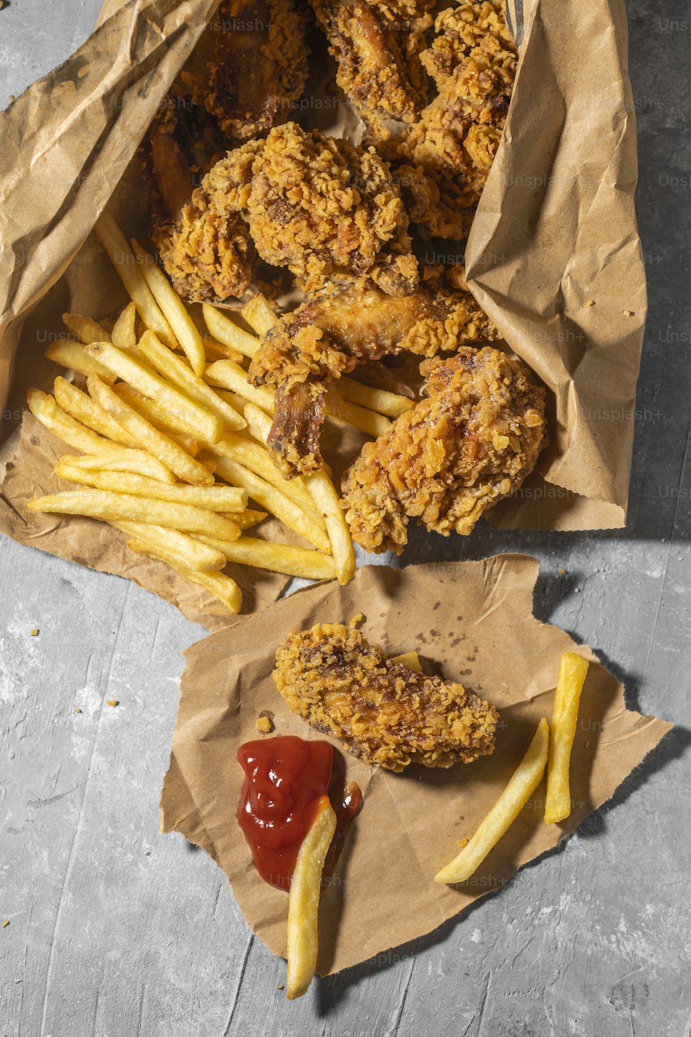 fried chicken and french fries with ketchup and ketchup