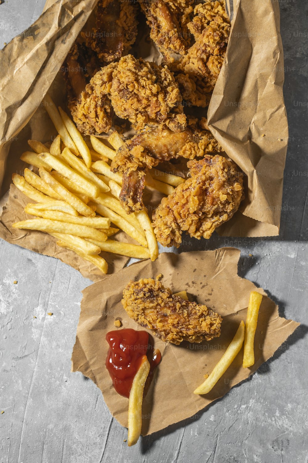 fried chicken and french fries with ketchup and ketchup
