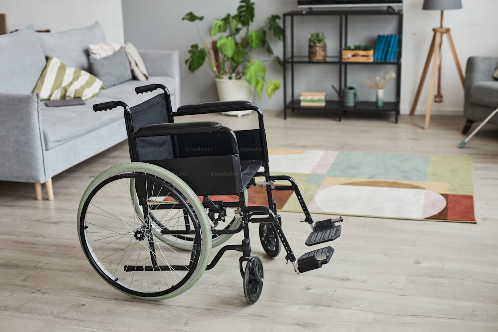 Full length background image of empty wheelchair in home interior, copy space