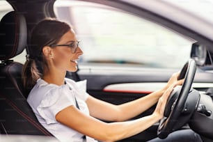 A young woman in a car got stacked in traffic. A woman pressing a horn and giving a signal to the other drivers. Woman in a car