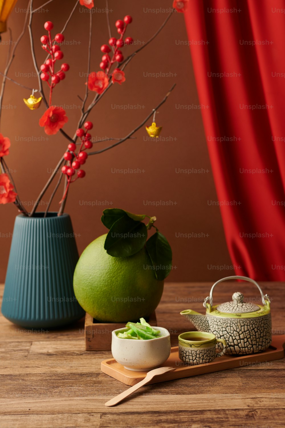 Big pomelo fruit, teapot, cup and candied fruits for Spring festival on wooden table
