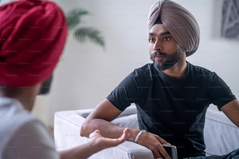 Conversation. Two men in turbans talking and looking involved