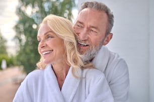 Happy morning. A happy mid aged couple at the balcony