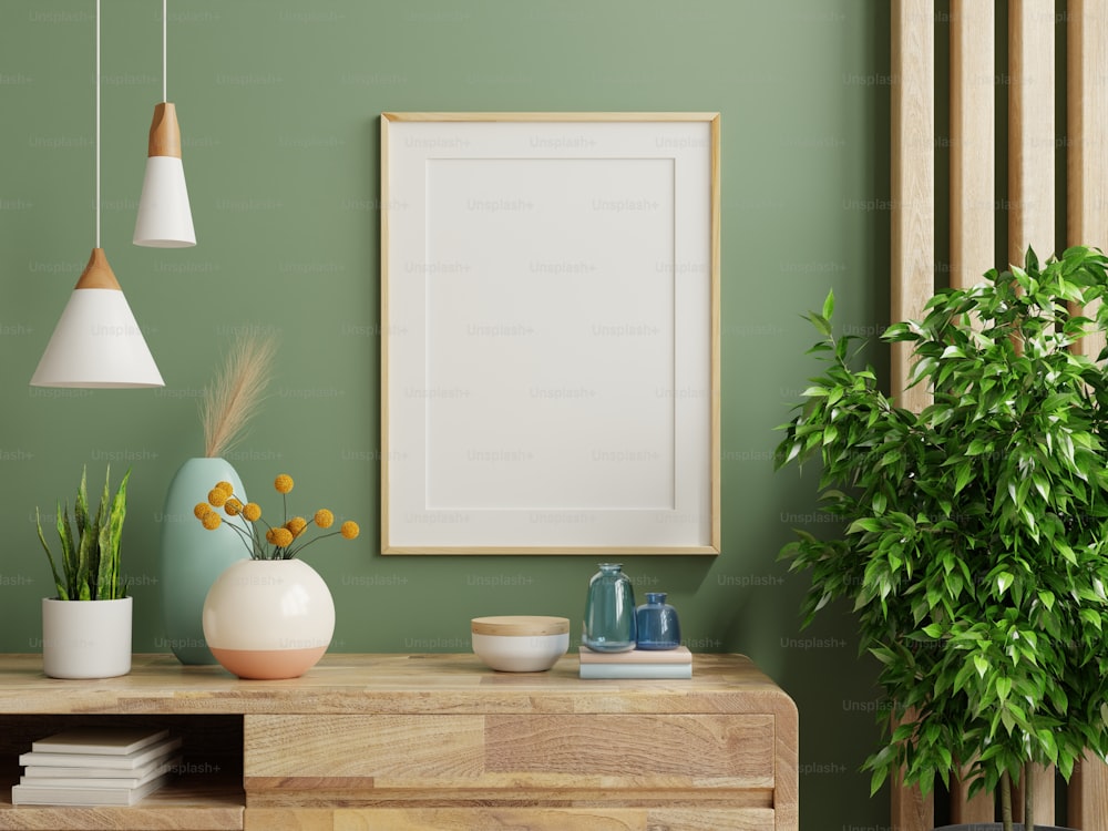 Maqueta del marco de fotos en la pared verde montado en el gabinete de madera.3d renderizado