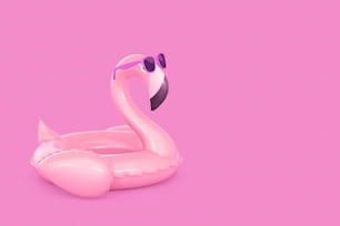 Flamant rose gonflable dans des lunettes de soleil sur fond rose. Rendu 3D