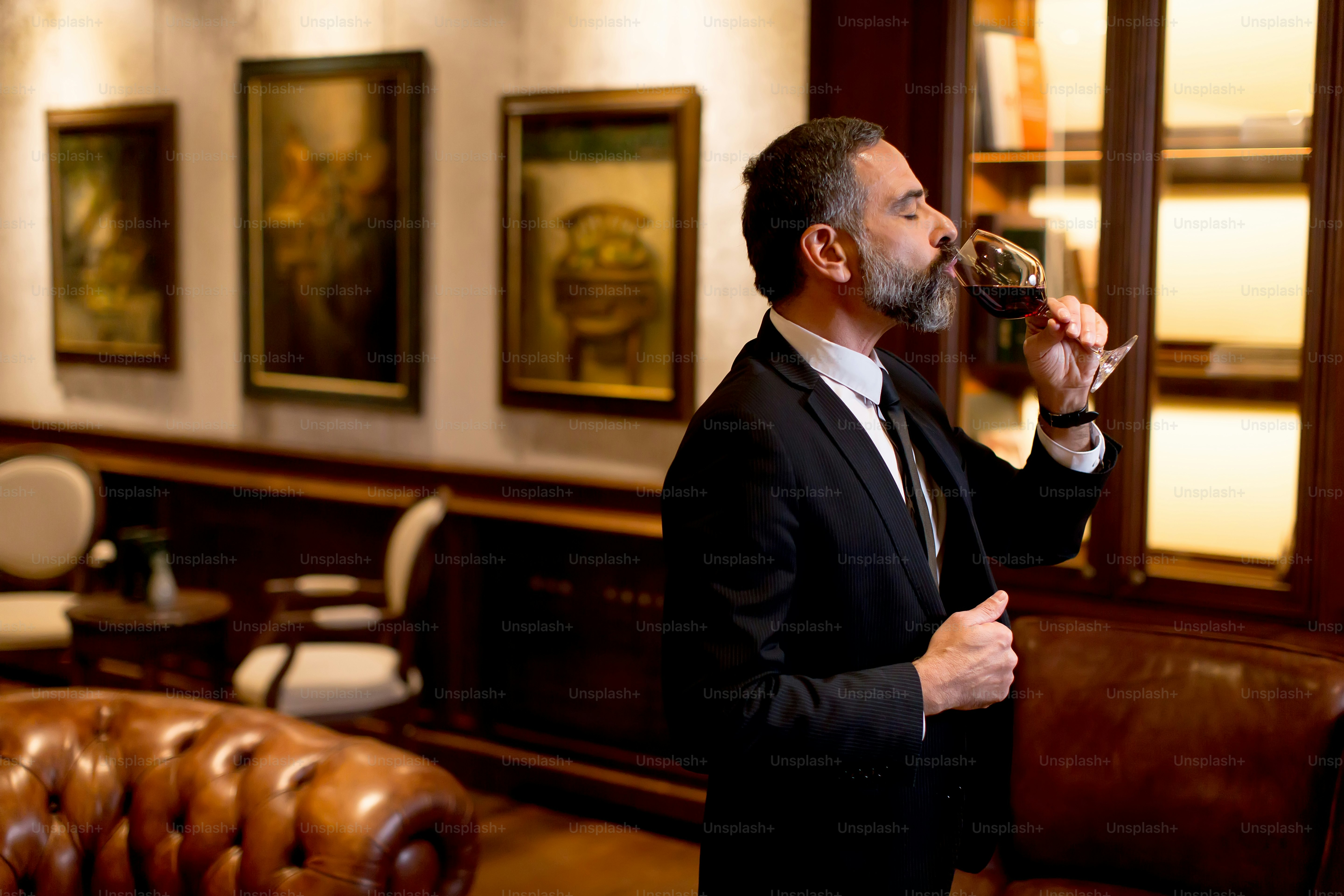 Handsome elegant businessman drinking red wine in bar photo – People ...