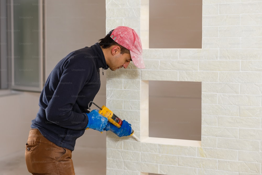 Yooung repairman carpenter working with paint painting