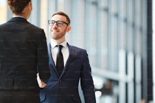 Successful agent shaking hand of foreign colleague by meeting on arrival in airport