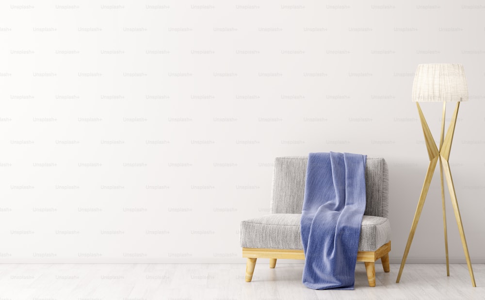 Interno del soggiorno con poltrona in velluto grigio, plaid blu e lampada da terra in legno su parete bianca rendering 3d