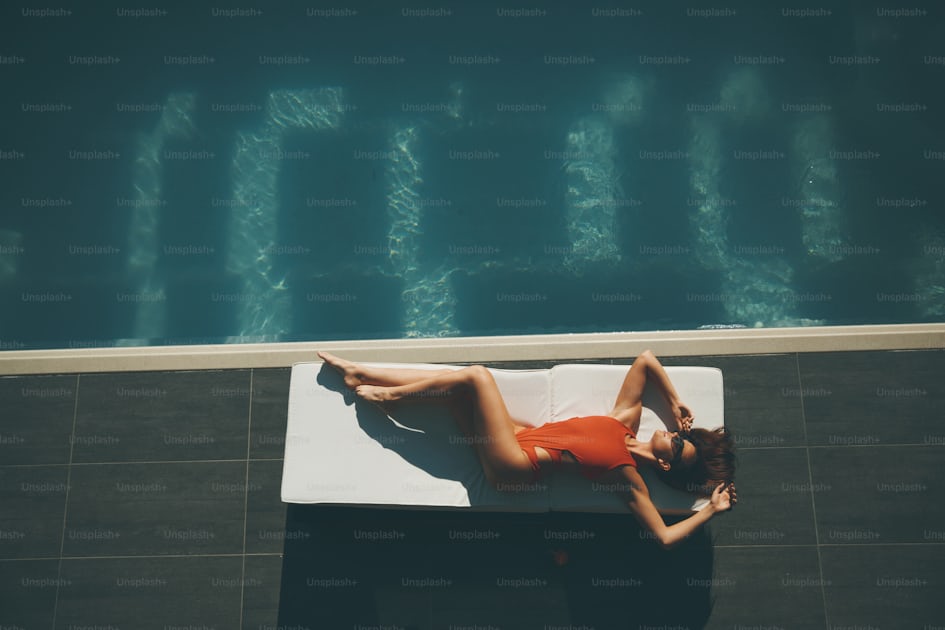 Young woman lying by swimming pool at hot summer day photo – Women Image on  Unsplash