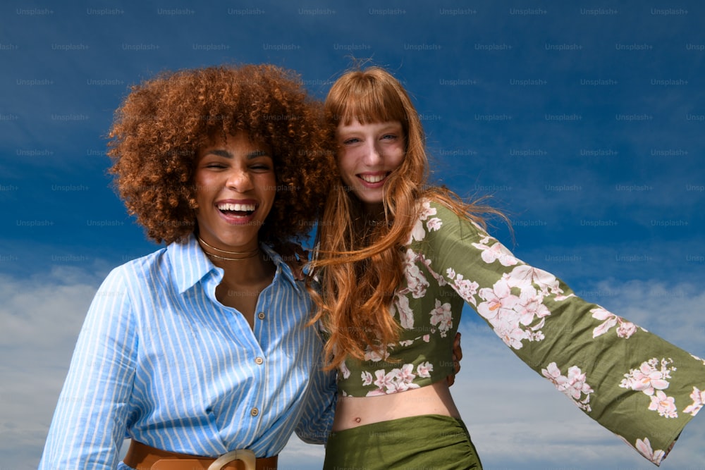 two women standing next to each other smiling