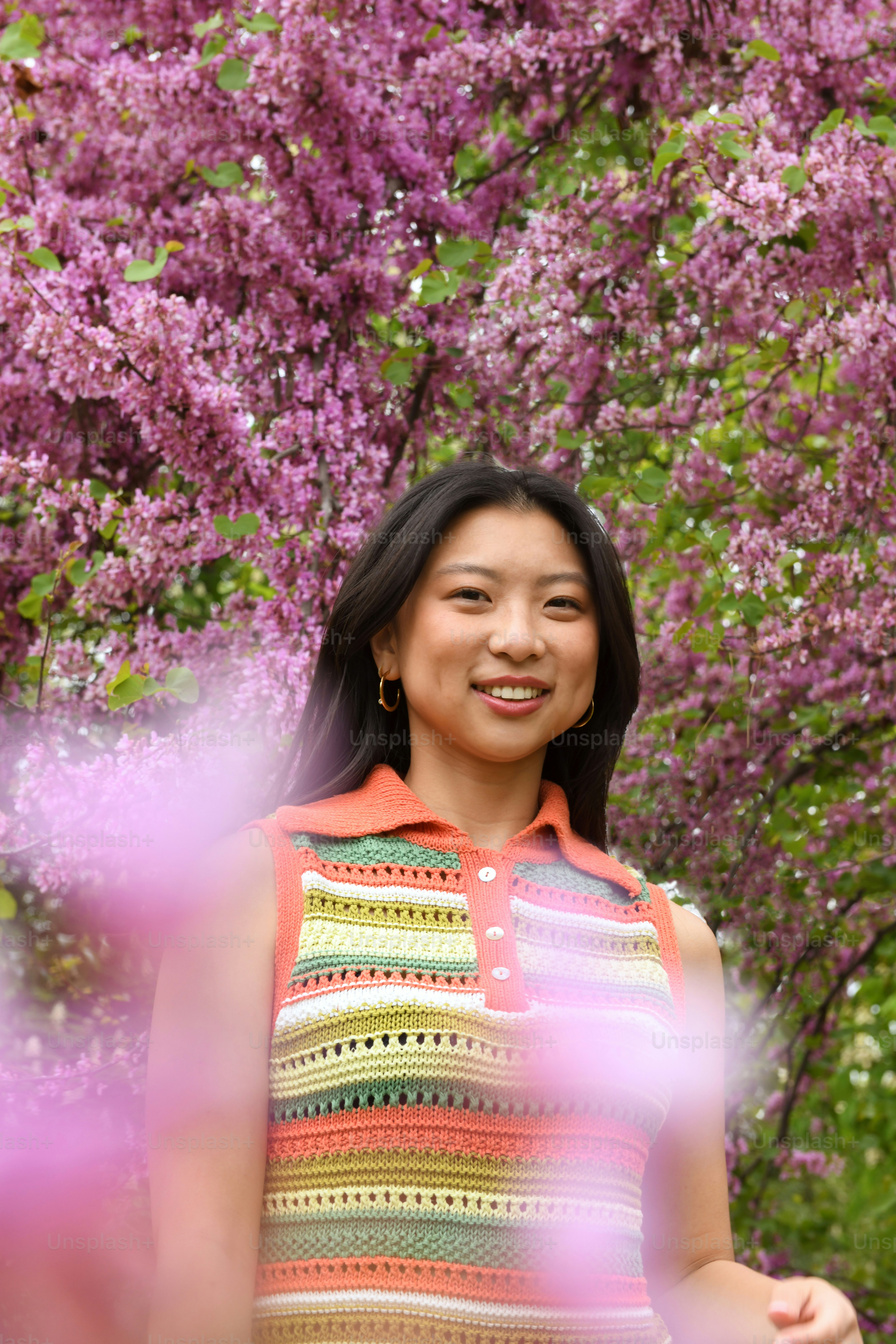 A woman with long red hair standing in front of a tree photo – Garden ...
