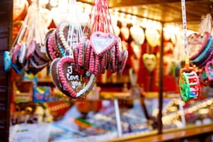 Gingerbread Hearts at German Christmas Market. Nuremberg, Munich, Berlin, Hamburg xmas market in Germany. On traditional ginger bread cookies written I love you called Lebkuchenherz in German.