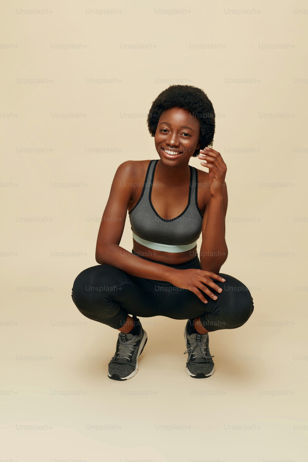 Fit Girl. Sporty African Woman Portrait. Beautiful Smiling Female In Sportswear Sitting On Hunkers. Fitness For Active Lifestyle.