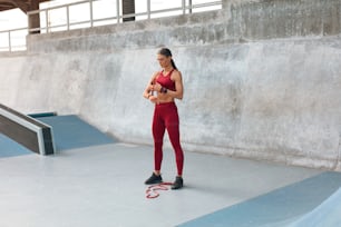 Workout. Woman With Resistance Band Getting Ready To Do Exercise On Stadium. Fitness Girl In Fashion Sportswear Training Outdoor For Strong Muscular Body. Sexy Female Going To Stretch.
