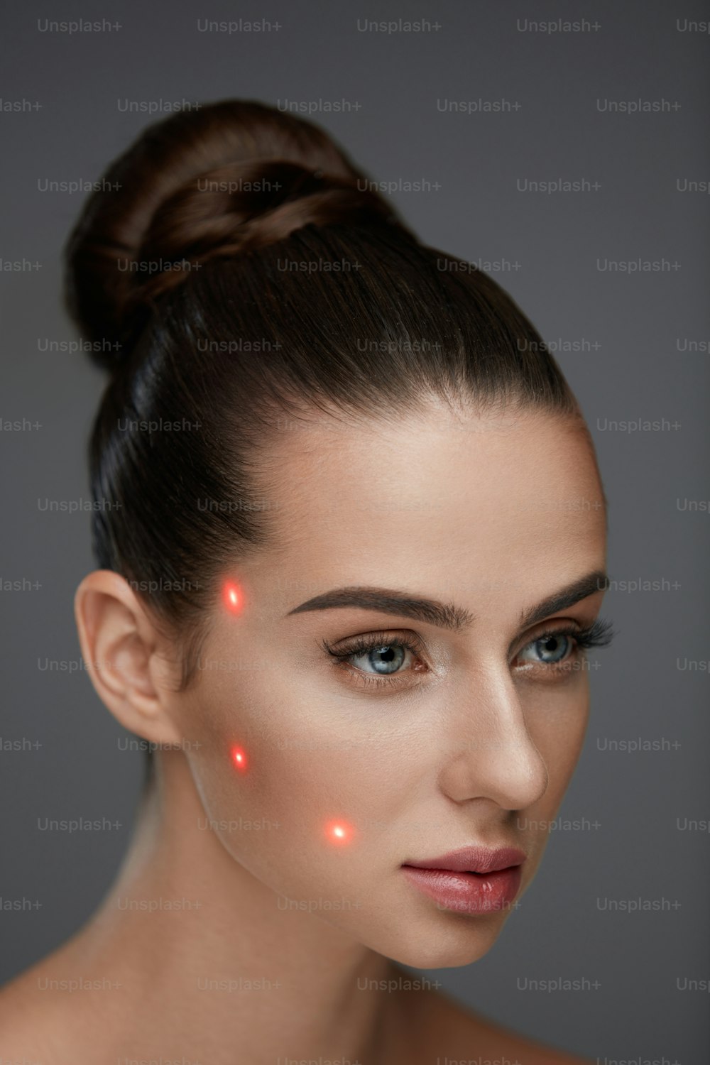 Beauty Treatment. Portrait Of Beautiful Young Woman With Soft Skin And Red Laser Points On Face. Closeup Of Sexy Healthy Woman Before Plastic Surgery On Grey Background. Cosmetology. High Resolution