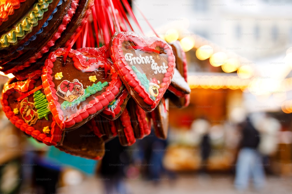 Gingerbread Hearts at German Christmas Market. Nuremberg, Munich, Berlin, Hamburg xmas market in Germany. On traditional ginger bread cookies written Merry Chrismtas called Lebkuchen in German.