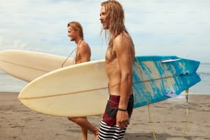 Surfing. Handsome Surfers With Surfboards. Young Men Walking On Ocean Beach. Active Lifestyle, Water Sport On Beautiful Sea Background.