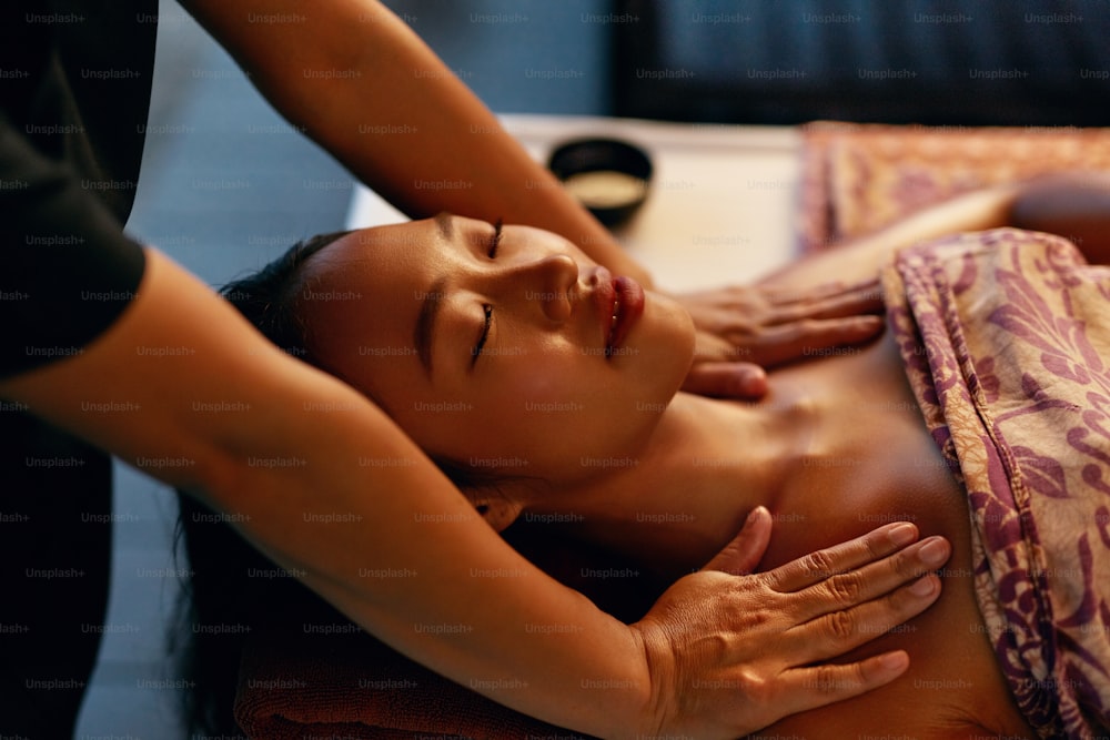 Spa Massage. Woman Getting Traditional Thai Body Care Therapy. Masseur Massaging Client Shoulders. High Resolution