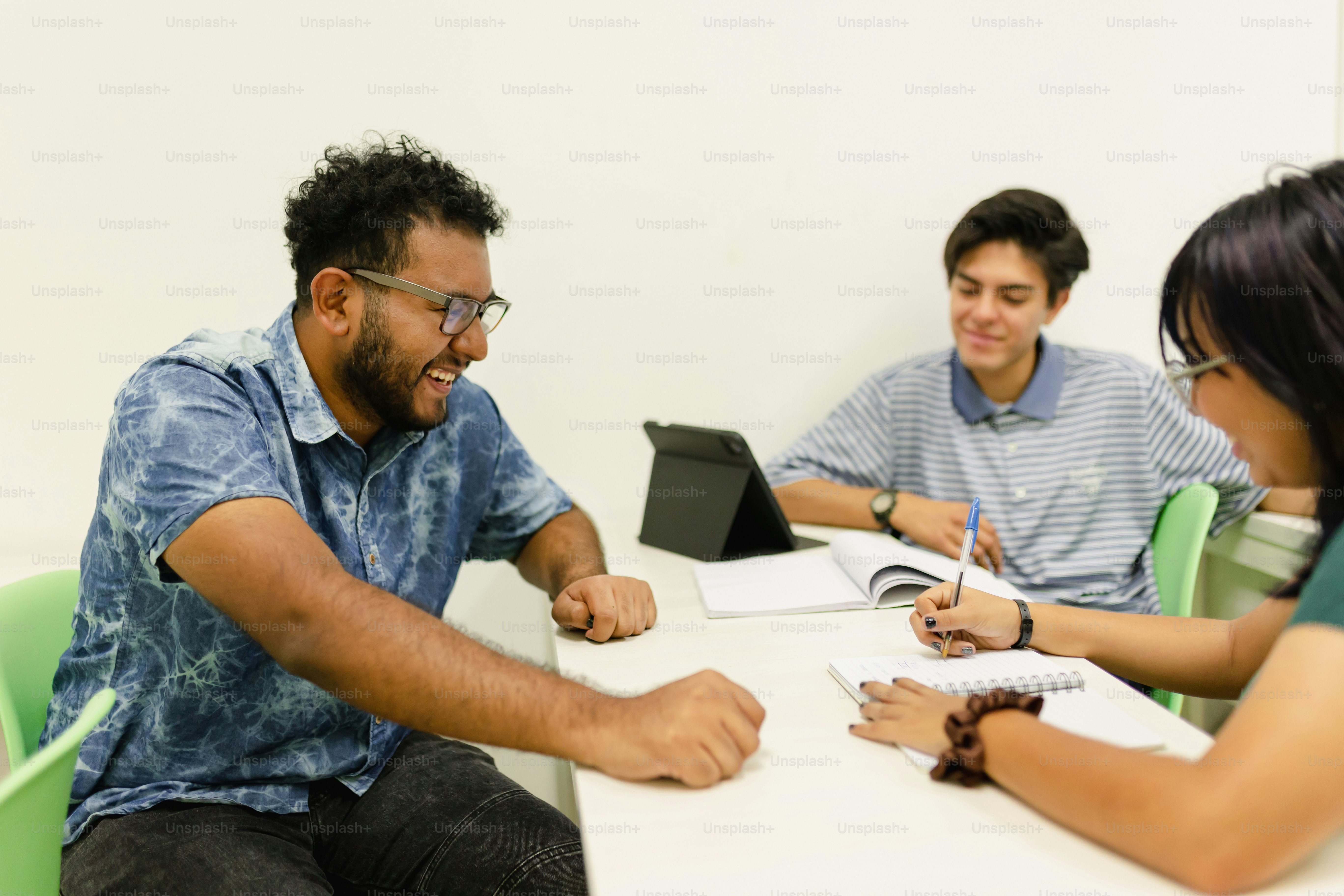 a group of people sitting around a white table